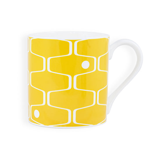 A mustard yellow mug featuring the net & ball pattern